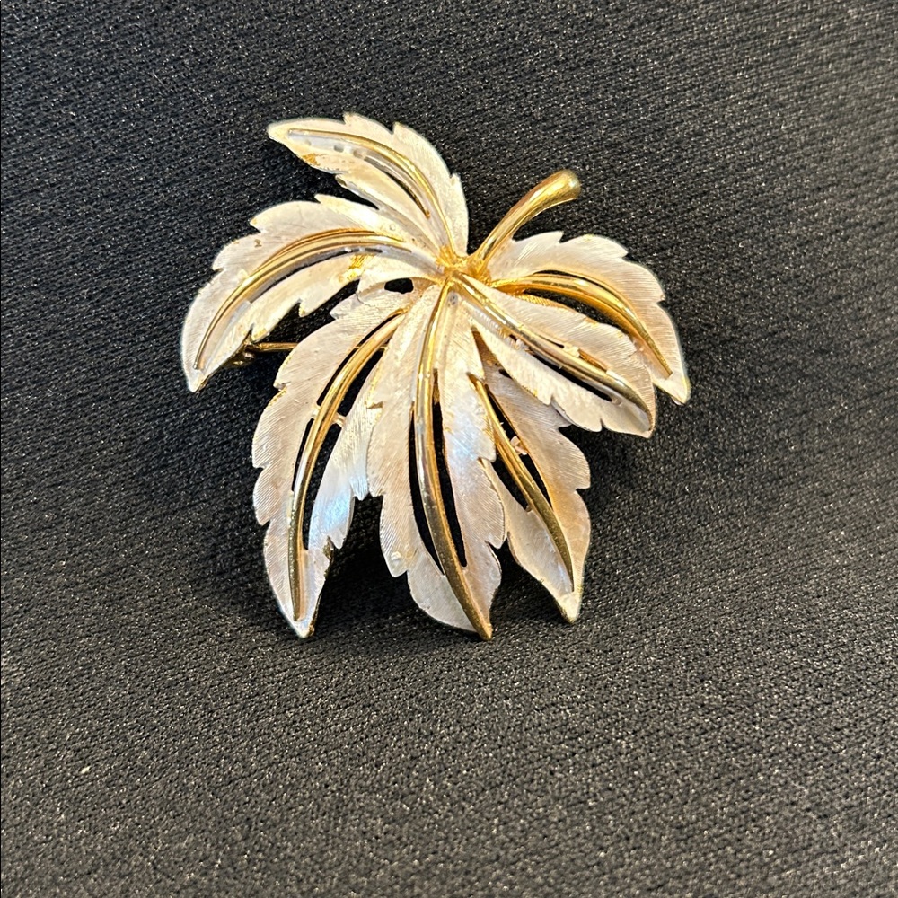JJ (Jonette Jewelry Company) white enamel leaf brooch with a gold-tone finish